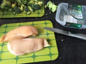 Knife and chicken on chopping board